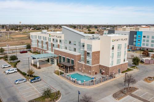 an aerial view of a hotel with a parking lot at Hyatt Place Dallas/The Colony in The Colony