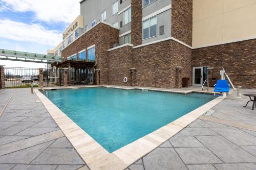 a swimming pool in front of a building at Hyatt Place Dallas/The Colony in The Colony