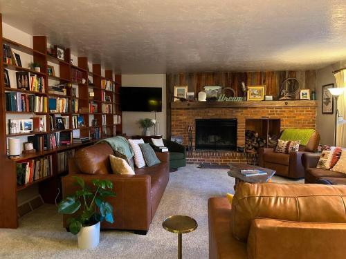 a living room with a couch and a fireplace at Devils Tower Lodge Bed & Breakfast in Devils Tower