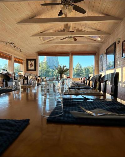 a large dining room with a long table and chairs at Devils Tower Lodge Bed & Breakfast in Devils Tower