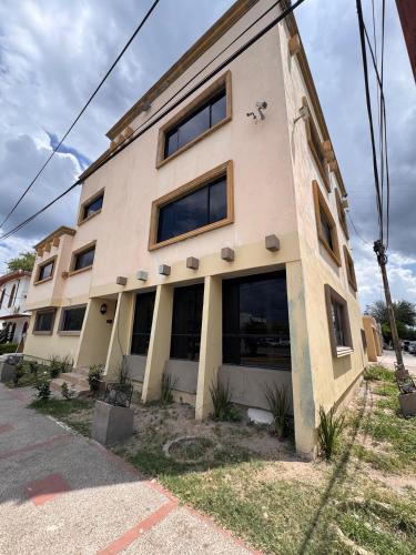 a building with large windows on the side of it at HOTEL MATAMOROS frente al consulado in Matamoros