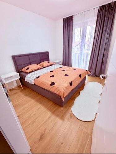 a bedroom with a bed and a wooden floor at Apartman Maras in Posušje