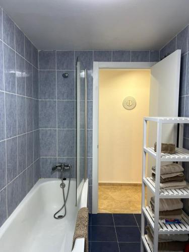 a bathroom with a shower and a bath tub at La Llum de Serra in Serra