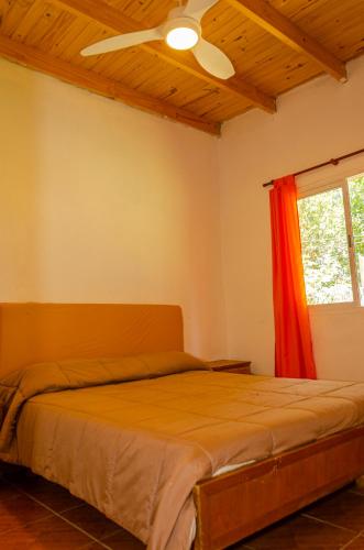 a bedroom with a bed with a ceiling fan at Quinta El Oasis in Junín