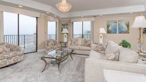 a living room with two couches and a table at Phoenix East 1401 in Orange Beach