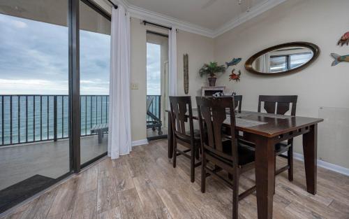 a dining room with a table and views of the ocean at Phoenix East 1405 in Orange Beach