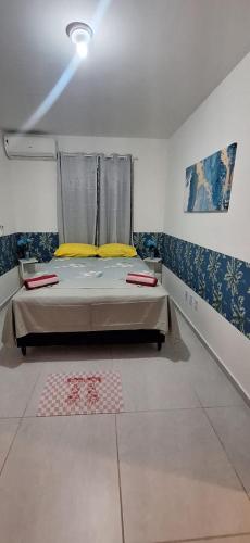 a bedroom with a bed in a room at Pedacinho de Lar in João Pessoa