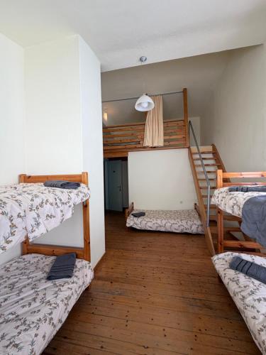 a room with three bunk beds and a staircase at Chalet Vasilitsa in Grevena