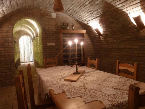 a dining room with a table in a brick wall at Kabóca Vendégház in Vác