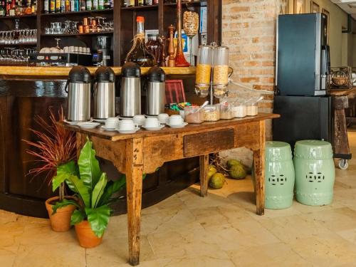 een houten tafel met een hoop drankjes erop bij Mercure São Paulo Ibirapuera Privilege in Sao Paulo