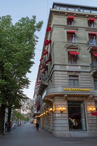 a tall building with a store on a street at Hotel St.Gotthard in Zürich