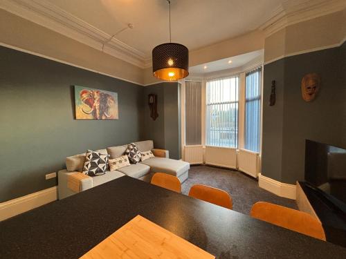 a living room with a couch and a table at Louise Suite in Southport