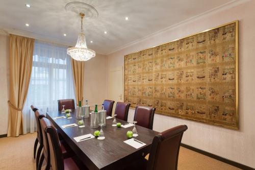 a dining room with a long table and chairs at Hotel St.Gotthard in Zürich