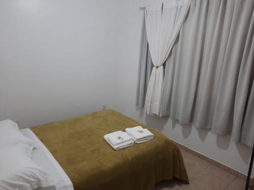 En eller flere senge i et værelse på Pousada Casa Rosa