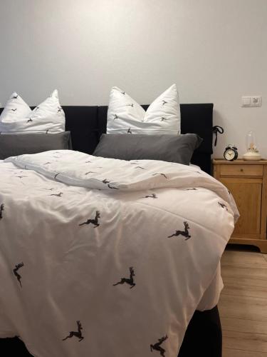 a bedroom with a bed with birds on it at Alpenheimat 1658 in Mittelberg