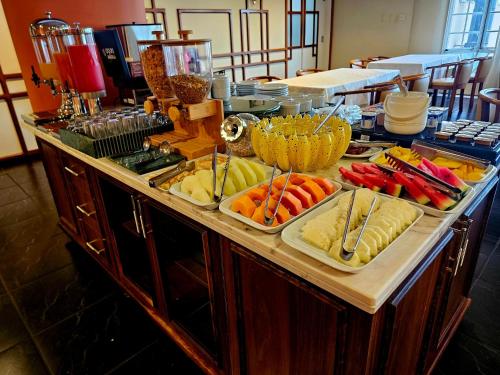 a buffet with different types of food on a table at Hotel Santoni in Guarapuava