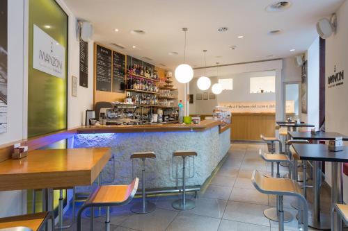 a restaurant with a bar with chairs and tables at Hotel St.Gotthard in Zürich
