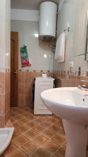 a bathroom with a white sink and a toilet at Spacious Waterfront 3BR - 2Bath & 3 Panoramic Balconies - Pogradec, Lake Ohrid in Pogradec