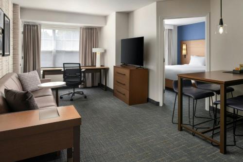 a hotel room with a couch and a bed at Residence Inn by Marriott Atlantic City Airport Egg Harbor Township in Egg Harbor Township