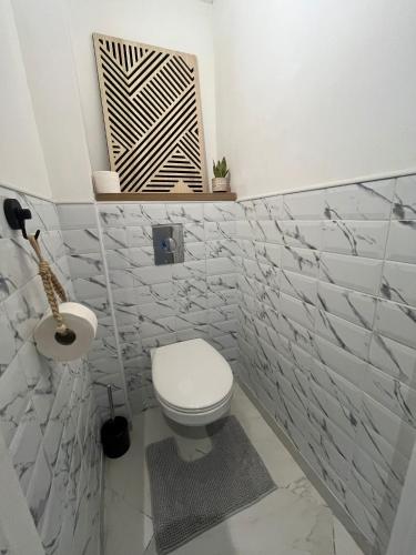 a bathroom with a toilet and a sink at T3 moderne - Clim - Parking privé 4 couchages in Decazeville