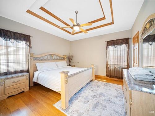 a bedroom with a bed and a ceiling fan at Beautiful home in Bridgeview! in Bridgeview