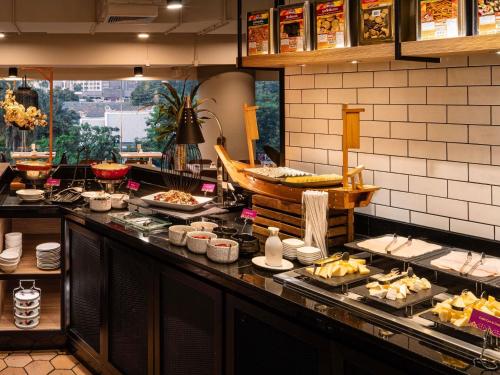 una fila di buffet con cibo esposto in un ristorante di Pullman Bangkok Hotel G a Bangkok