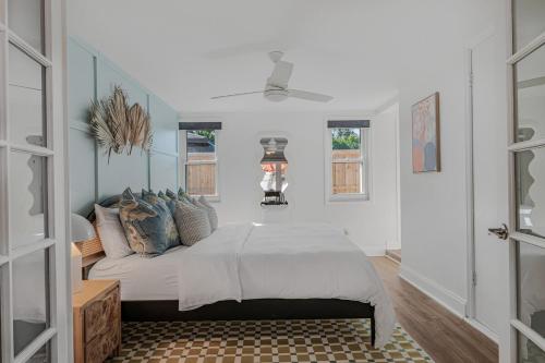 a bedroom with a bed in a room with windows at The Art Deco Den in Tampa