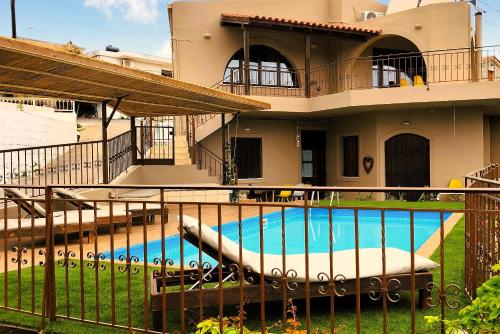 a house with a swimming pool in front of it at Elia Woodstone Houses in Elaía