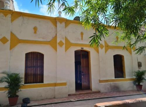 a building with two doors and trees in front of it at Casa Faccioli in Mompos