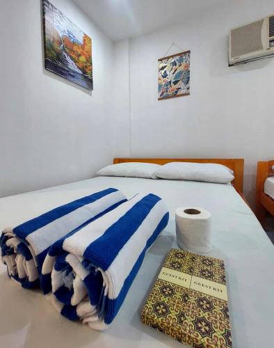 a bedroom with a bed with blue and white towels at RenSea Haven Boracay Rm10 in Boracay