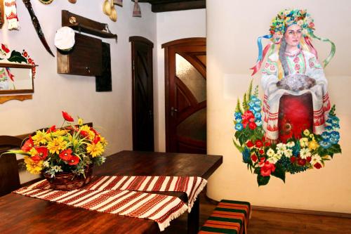 a living room filled with furniture and flowers at Bilya Richky Hotel in Kamianets-Podilskyi