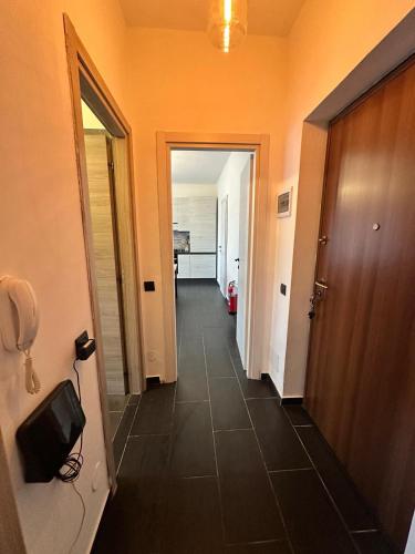 a hallway with a phone and a hallway with an orange wall at Dante appartamento in Fagnano Olona