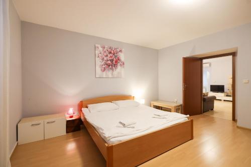 a bedroom with a bed in a room at Quattro Cantoni Apartment in Zadar