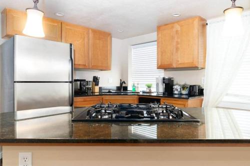 a kitchen with a stove and a refrigerator at Cozy 1Bdrm•Self Check-in•Downtown in Salt Lake City