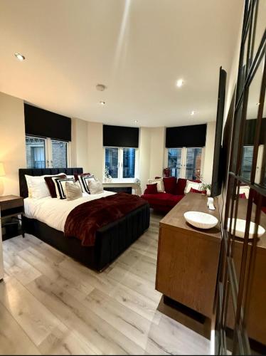 a bedroom with a bed and a living room at Cozy Studio Flat in Bradford City Centre in Bradford