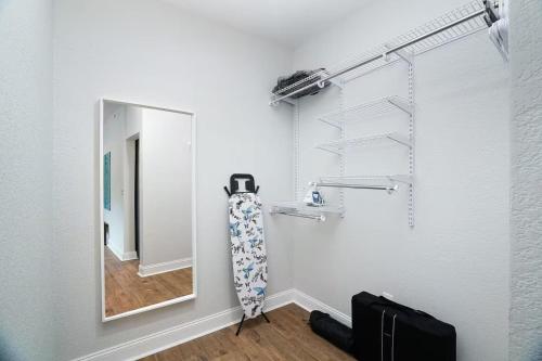a white room with a mirror and a towel at Lone Star Landing in San Antonio