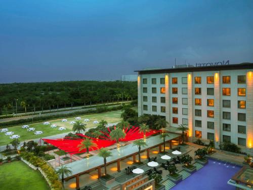 an overhead view of a hotel with a pool and a building at Novotel Hyderabad Airport in Hyderabad