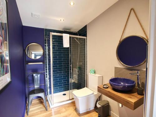 a bathroom with a blue sink and a toilet at Narrowgate Castle Ocean Blue Lodge Central Alnwick Inc Sofa Bed in Alnwick