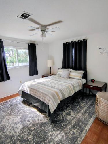 a bedroom with a bed and a ceiling fan at Seagull`s Rest in Navarre