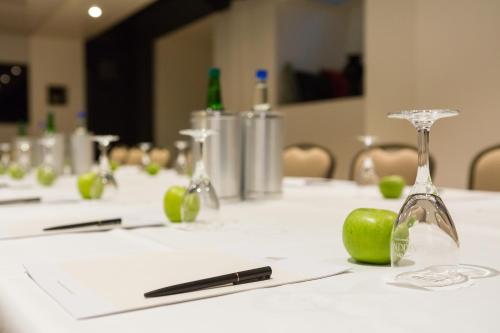 a table with wine glasses and a green apple on it at Hotel St.Gotthard in Zürich
