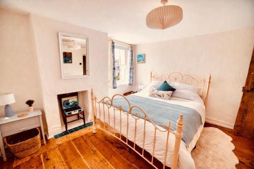 a bedroom with a bed and a fireplace in it at Beautiful Old Cottage near the Seafront in Eastbourne