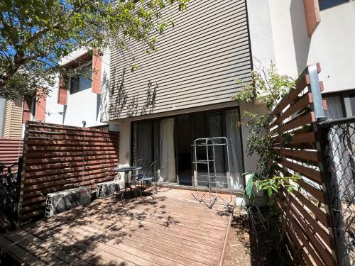 a house with a wooden porch with a fence at Spacious Family Townhouse near Kingston & Manuka in Fyshwick