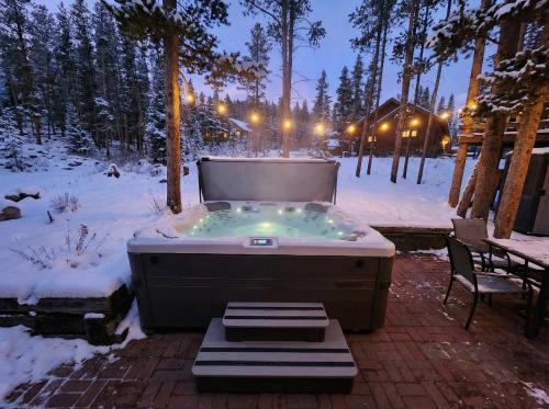a jacuzzi tub in a snow covered yard at Stunning 4 BR Home Mountain Views Tranquil Setting in Breckenridge