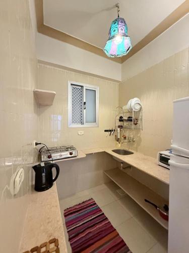 a kitchen with a sink and a refrigerator at Kabeel's House in Dahab