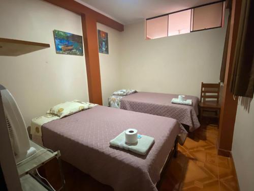 Giường trong phòng chung tại Casa Hospedaje Inkani