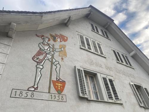 a painting of a man on the side of a building at Cara Nima Schwyz in Schwyz