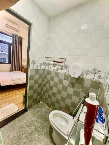 a bathroom with a toilet in a room at Naomi House Phan Thiet in Phan Thiet
