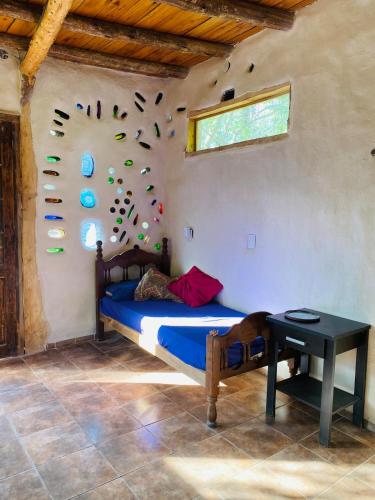 a bedroom with a bed with shoes on the wall at Icho's mud house in Villa Icho Cruz