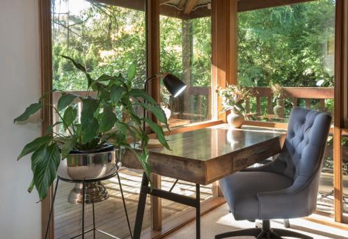 an office with a desk and a potted plant at Botanica Retreat Garden Cabin in Olinda in Olinda