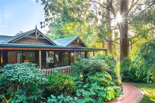 a house with a garden in front of it at Botanica Retreat Garden Cabin in Olinda in Olinda